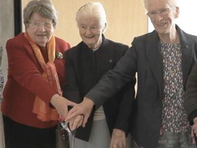 Sisters Evelyn, Bernadette and Marian cut jubilee cake